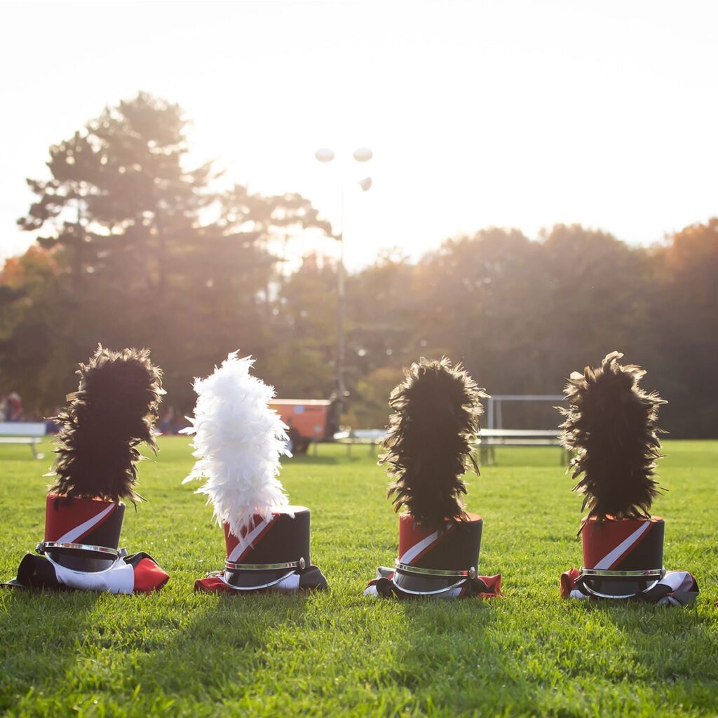 band hats lined up in the grass