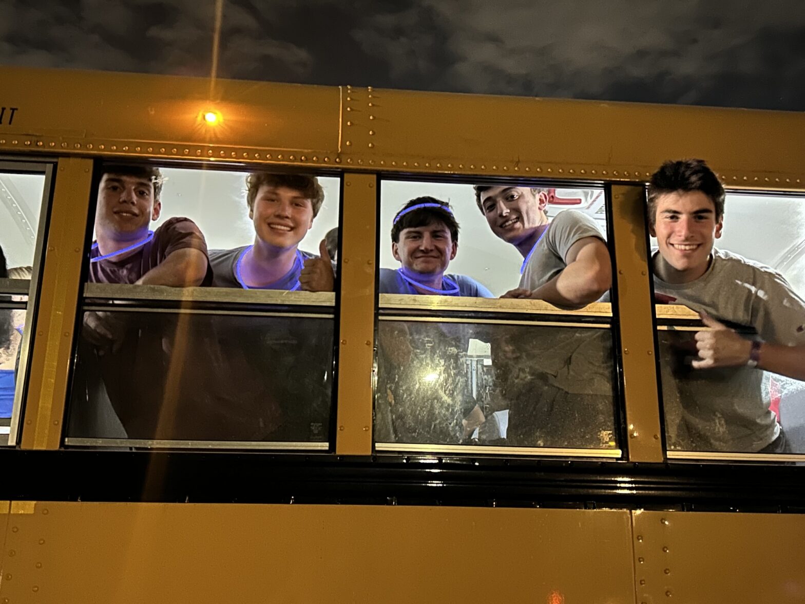students on school bus during midnight madness